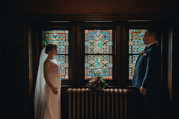 Bride and groom portrait with stained glass at Knowlton Mansion