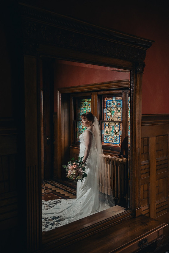 Bride and groom portrait with stained glass at Knowlton Mansion