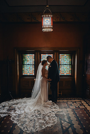 Bride and groom portrait with stained glass at Knowlton Mansion